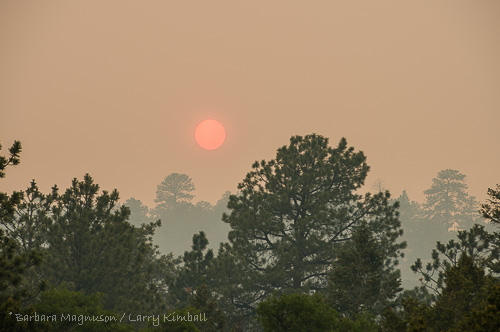 Smoke from West Fork complex wildfire, about 90 air miles southwest of us, obscures evening sun.