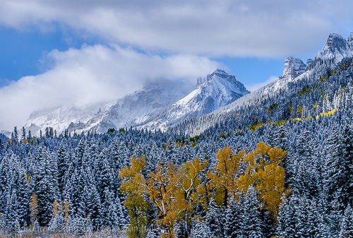 New snow and storm clouds shroud mountain tops along the Cimarron River
